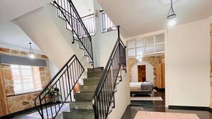 A staircase with black railings leading to a second floor.