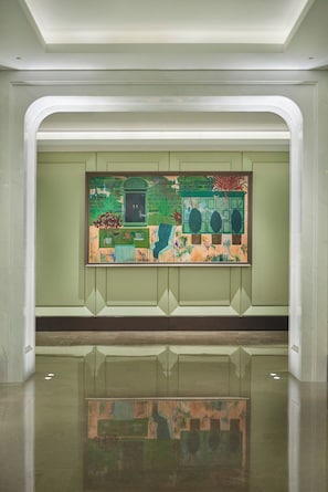 A modern interior with a reflective floor, a large abstract painting on the wall, and a clean, minimalist design.