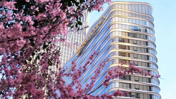 A modern high-rise building with a curved facade and a prominent yellow sign. - Shangri-La Qiantan, Shanghai (Shanghai)