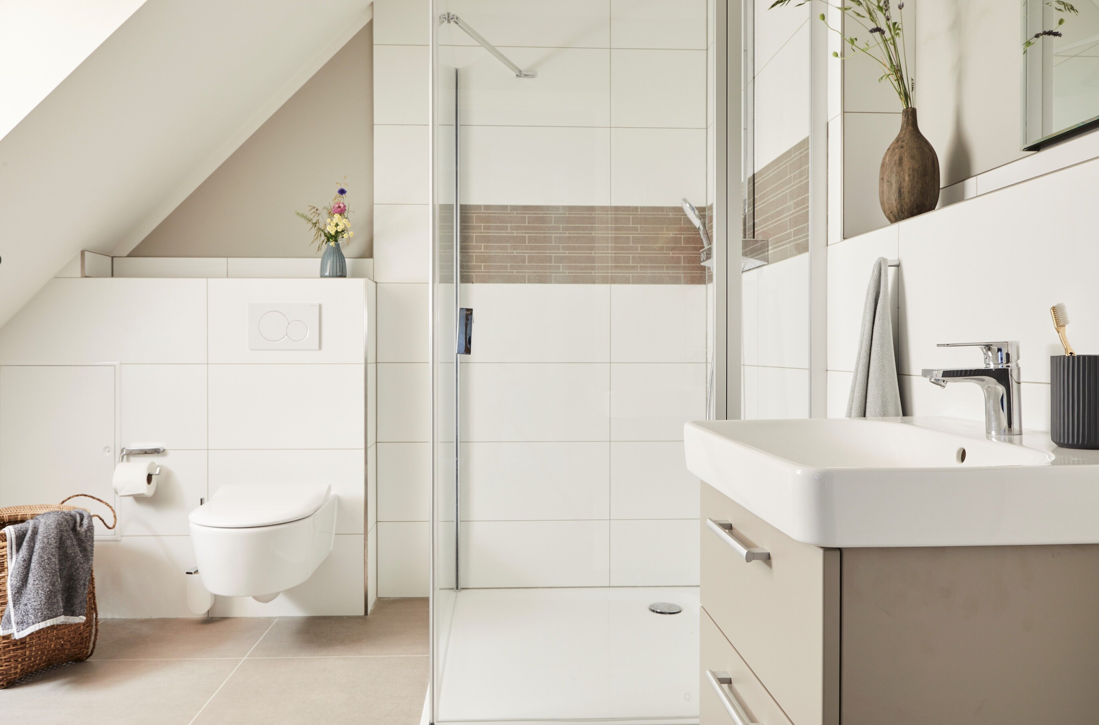 A modern bathroom with a shower, toilet, and sink.