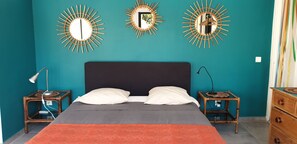 A bedroom with a bed, two nightstands, a dresser, and three wall mirrors. - House with a large pool and a magnificent view (La Londe-les-Maures)