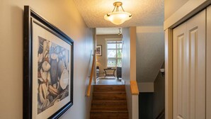 A staircase with wooden steps leading to a landing. - 2 Bedroom Sooke Townhome (Sooke)
