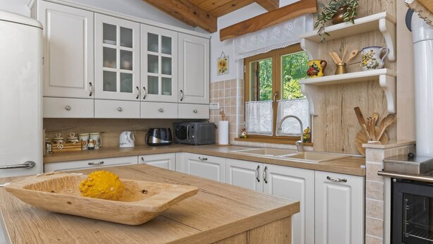 A kitchen with white cabinets, a wooden countertop, a microwave, and a stove. - Casa Mira - Two Bedroom Holiday Home with Pool (Pazin)