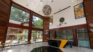 A spacious lobby with large windows, a reception desk, and a decorative chandelier. - Phumontra Resort Nakhon Nayok (Nakhon Nayok)