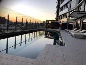 Relax by the pool surrounded by a stunning view of the city.