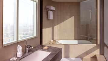 A modern bathroom with a large window, a bathtub, and a shower.
