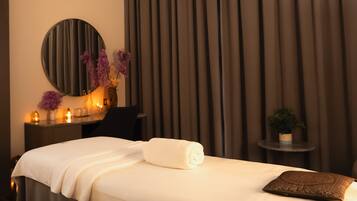 Relax in a serene space with a comfortable bed, a stylish mirror, and a cozy armchair.