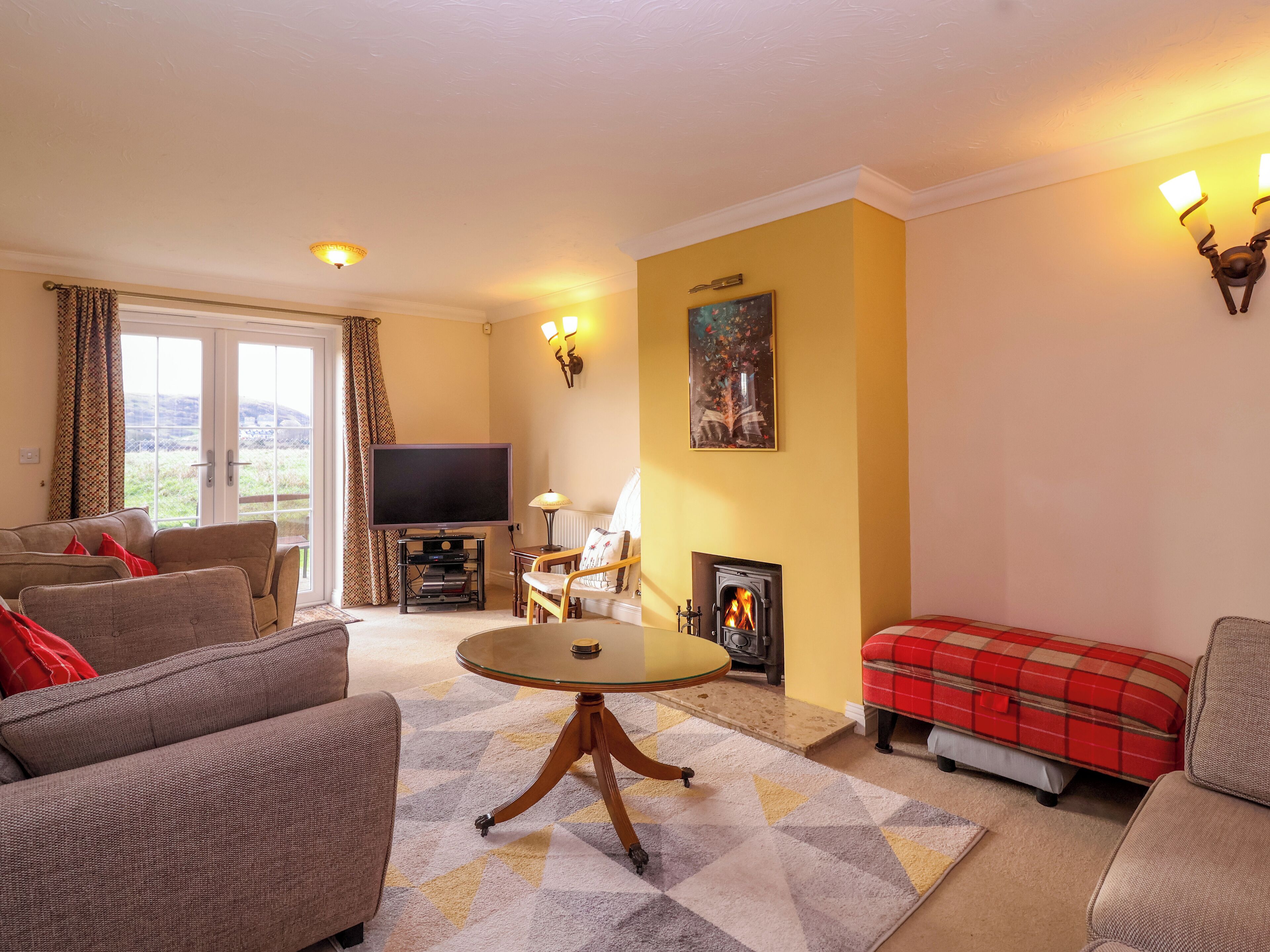 A living room with a fireplace, a television, and a sofa.