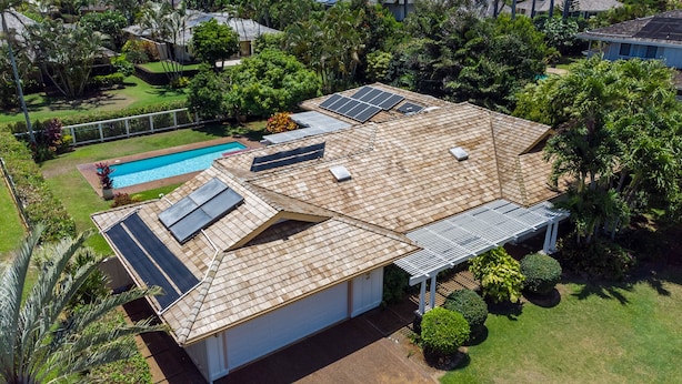 Une propriété résidentielle dotée d’une piscine, de panneaux solaires et d’un jardin bien entretenu.
