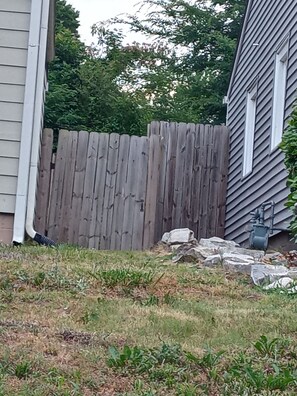 outdoor space with a well-maintained fence and lush greenery.