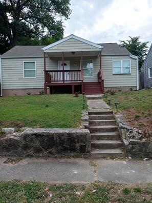 Stroll up to the front porch and enter this charming home with a gabled roof.