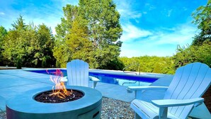 An outdoor pool area with a fire pit and Adirondack chairs. - Bourbon Country Lodge • 5 Acre Resort Pool+Hot Tub (Louisville)