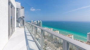A high-rise building with a balcony overlooking a coastal cityscape and ocean. - Hyde Beach House Luxury Condo-resort 2 Bedroom Condo by RedAwning (Hollywood)