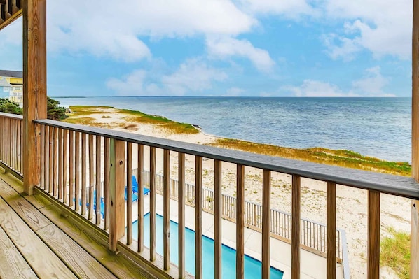 Enjoy a relaxing ocean view from the deck, adjacent to a pool.