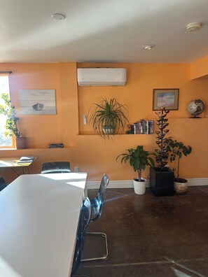 A conference room with a white table, chairs, and potted plants. - Lakefront, Beach, Fishing, Hot Tub, Gated, Fire Pit (Denver)