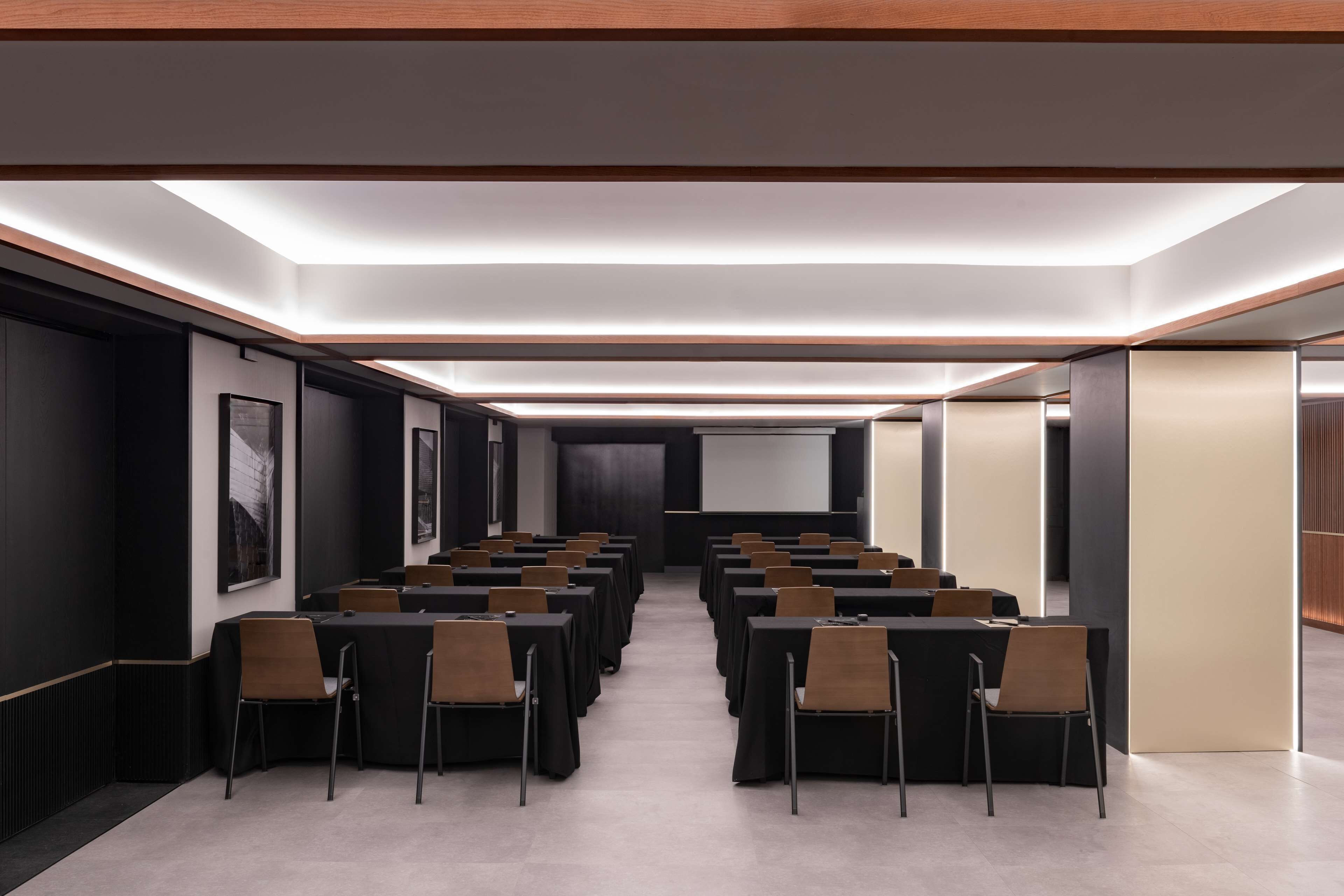 A conference room with tables and chairs arranged for meetings.