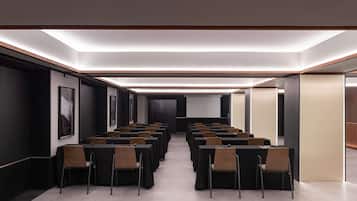 A conference room with tables and chairs arranged for meetings.