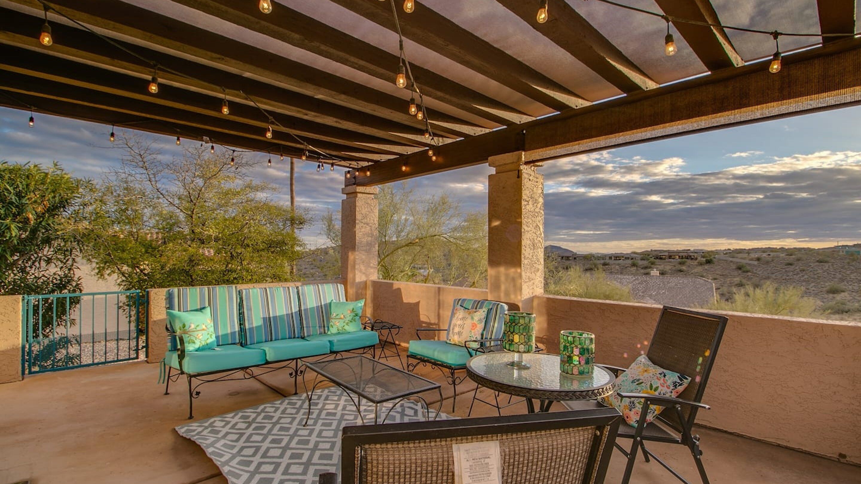 An outdoor patio with a sofa, chairs, and a table.