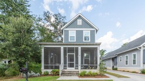 A two-story house with a porch, a mailbox, and a well-maintained lawn. - Old Town Bluffton Home + FREE Golf Cart Luxury Home - Sleeps 8 (Bluffton)
