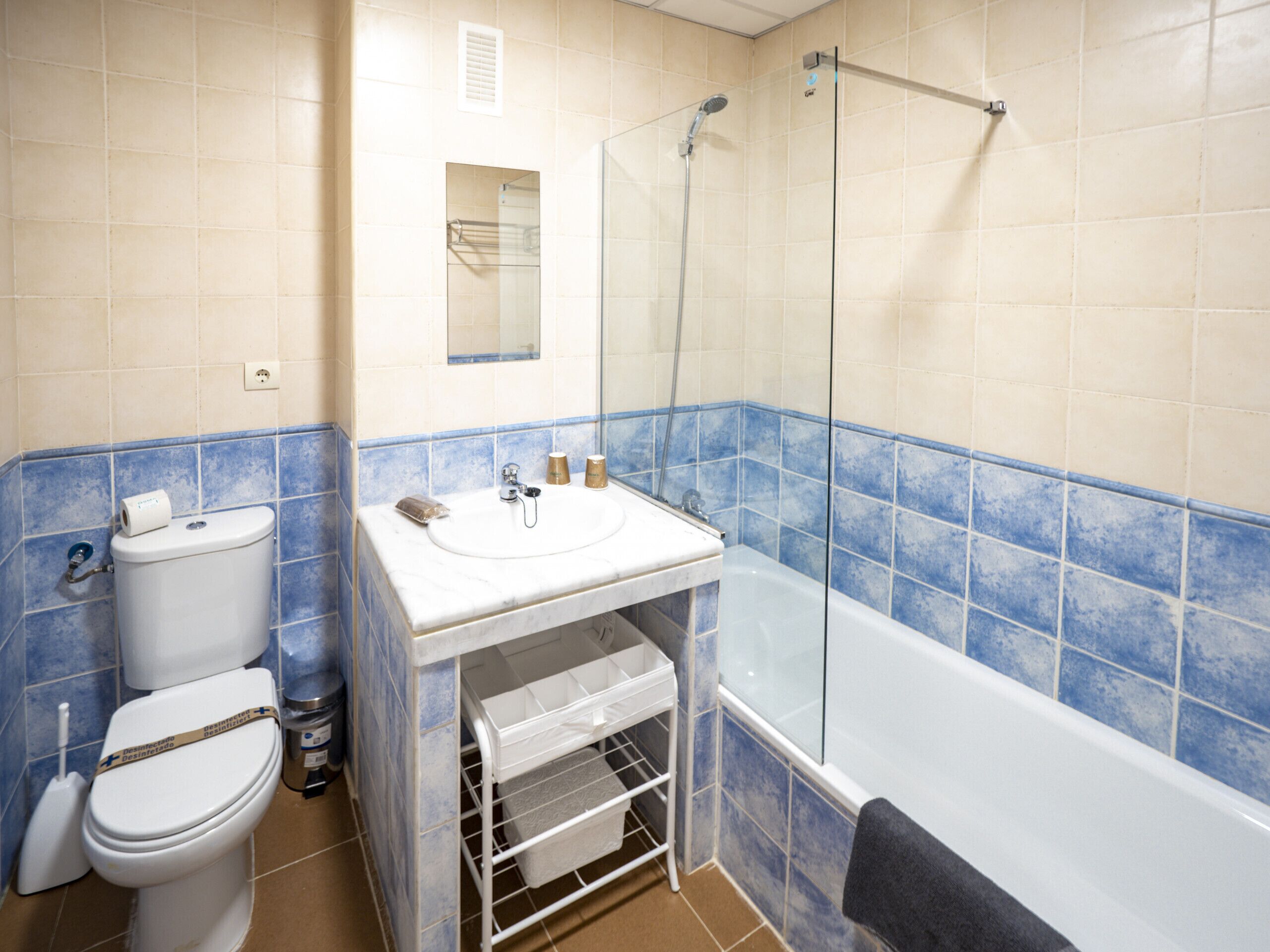 A bathroom with a toilet, sink, and bathtub.