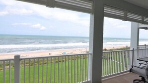 A balcony with a view of the beach and ocean. - Luxurious Ocean- Front 5th Floor – 3/3 Corner Unit – Sleeps 8 (Palm Coast)