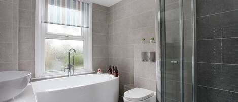 Bathtub, hair dryer, towels, soap