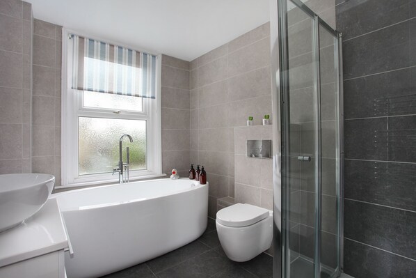 Bathtub, hair dryer, towels, soap