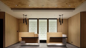 A modern reception area with wooden paneling, two reception desks, and pendant lighting. - Fairfield by Marriott Gifu Takayama Shirakawa Go (Takayama)