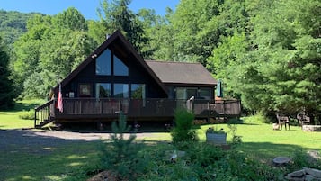 Guests can enjoy the tranquil surroundings from the cabin's large windows and expansive deck.