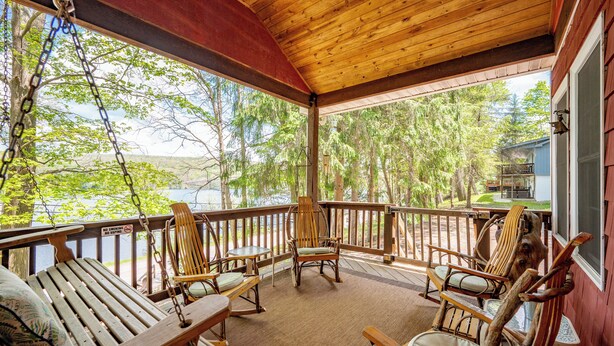 A wooden deck with rocking chairs and a view of a lake. - Charming Dog Friendly Cottage w/ Dock & Fire Pit (Mc Henry)