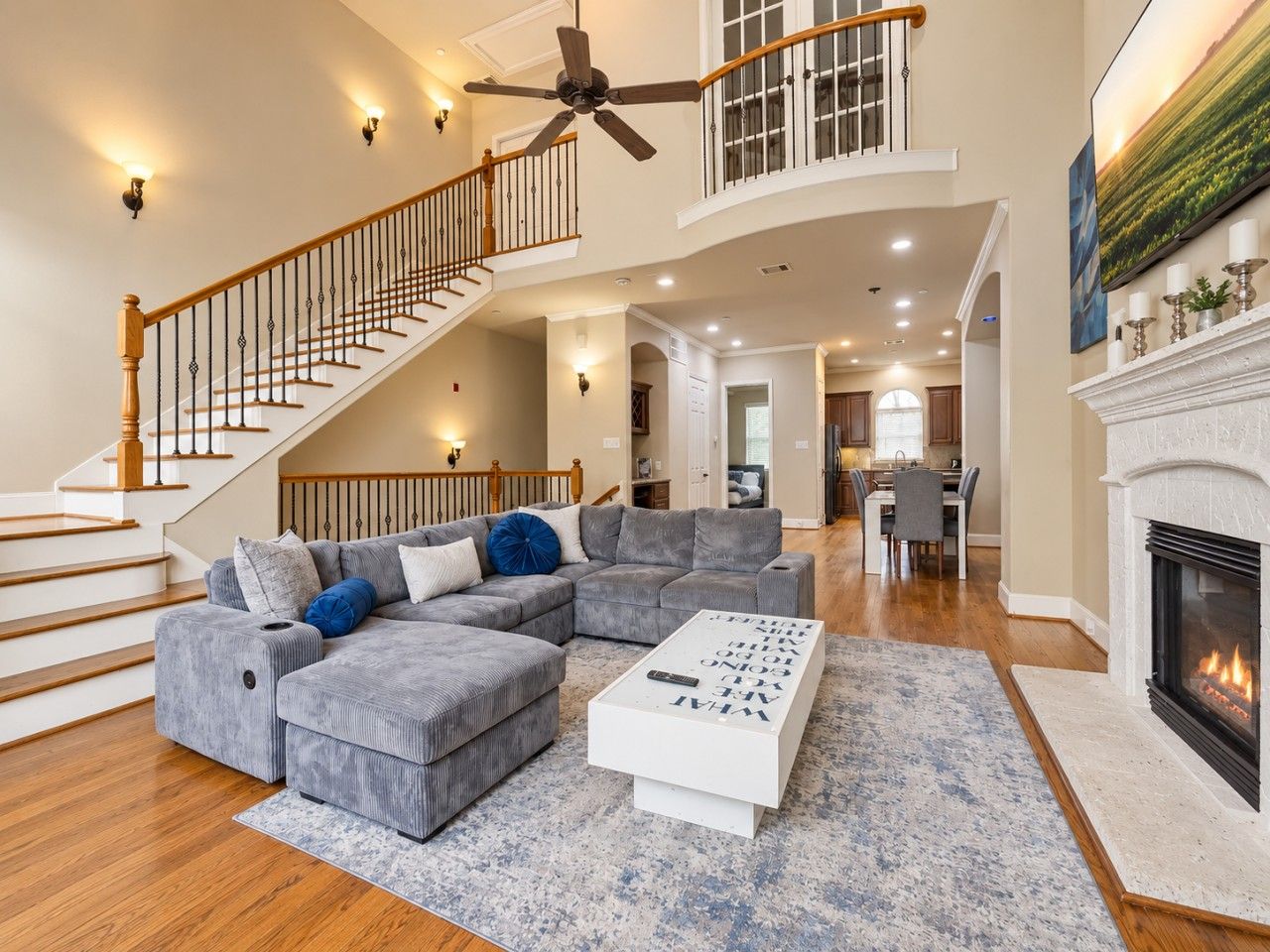 A spacious living room with a sectional sofa, a coffee table, and a fireplace.