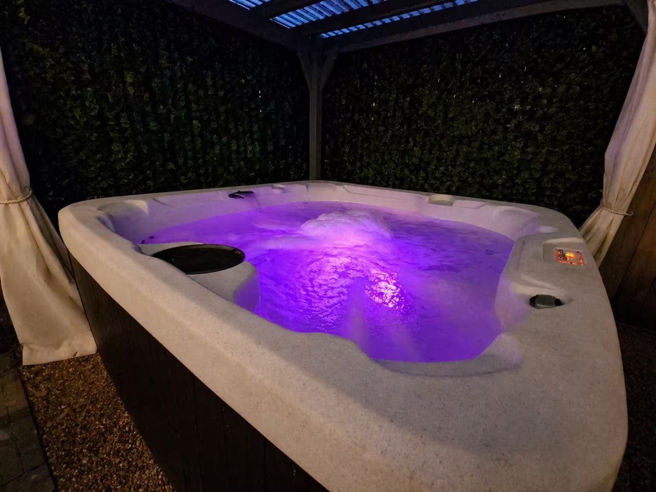 Private backyard hot tub tucked beneath a pergola, creating a relaxing outdoor retreat to enjoy throughout your stay.