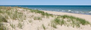 A beach with sand dunes and grass. - The "Pool Barn Camper" w/Hot Tub near Indiana Dunes (Porter)