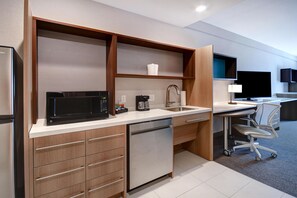 A modern kitchen with a built-in microwave, coffee maker, and dishwasher. - Home2 Suites BY Hilton Tucson Downtown (Tucson)