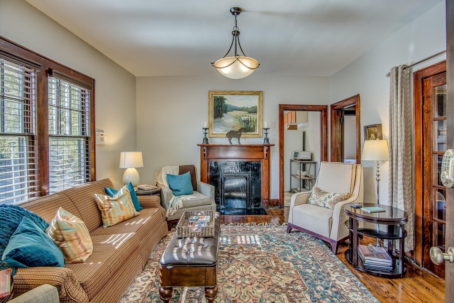 A living room with a fireplace, a sofa, a chair, and a coffee table.
