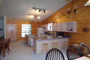 Enjoy cooking in this well-equipped kitchen with a central island and dining area.