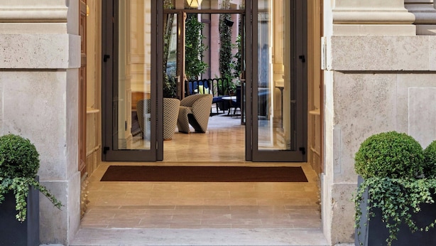A grand entrance with a glass door, a balcony with ornate railings, and a number '26' on the wall. - W Rome (Rome)