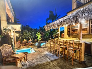 A poolside area with a bar and seating.