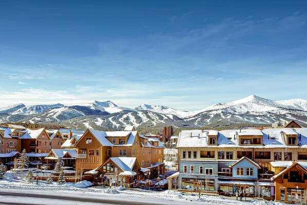 Experience the charm of a historic mountain town, surrounded by snow-capped peaks and picturesque buildings.