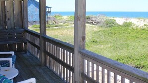 A wooden deck with outdoor seating and a view of the beach and ocean. - Oceanfront townhome with sound access in Duck! (Duck)