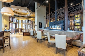 Relax in a cozy lounge area with sofas, chairs, and a fireplace.