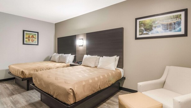 A hotel room with two beds, a sofa, and a small table. - Quality Inn & Suites Fort Worth - Fossil Creek (Fort Worth)