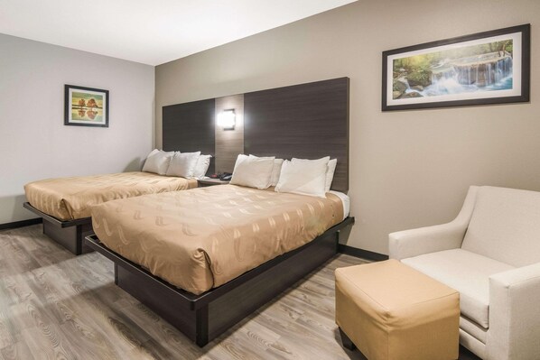 A hotel room with two beds, a sofa, and a small table. - Quality Inn & Suites Fort Worth - Fossil Creek (Fort Worth)