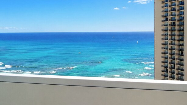 A high-rise building with a view of the ocean and a clear sky. - "STEPS AWAY FROM THE WAIKIKI BEACH STUDIO WITH OCEAN VIEW" (Honolulu)