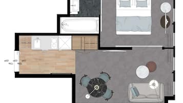 Distribución de un apartamento de una habitación, que incluye un baño, una kitchenette, una sala de estar con sofá y mesa de centro, y un comedor con mesa y sillas.