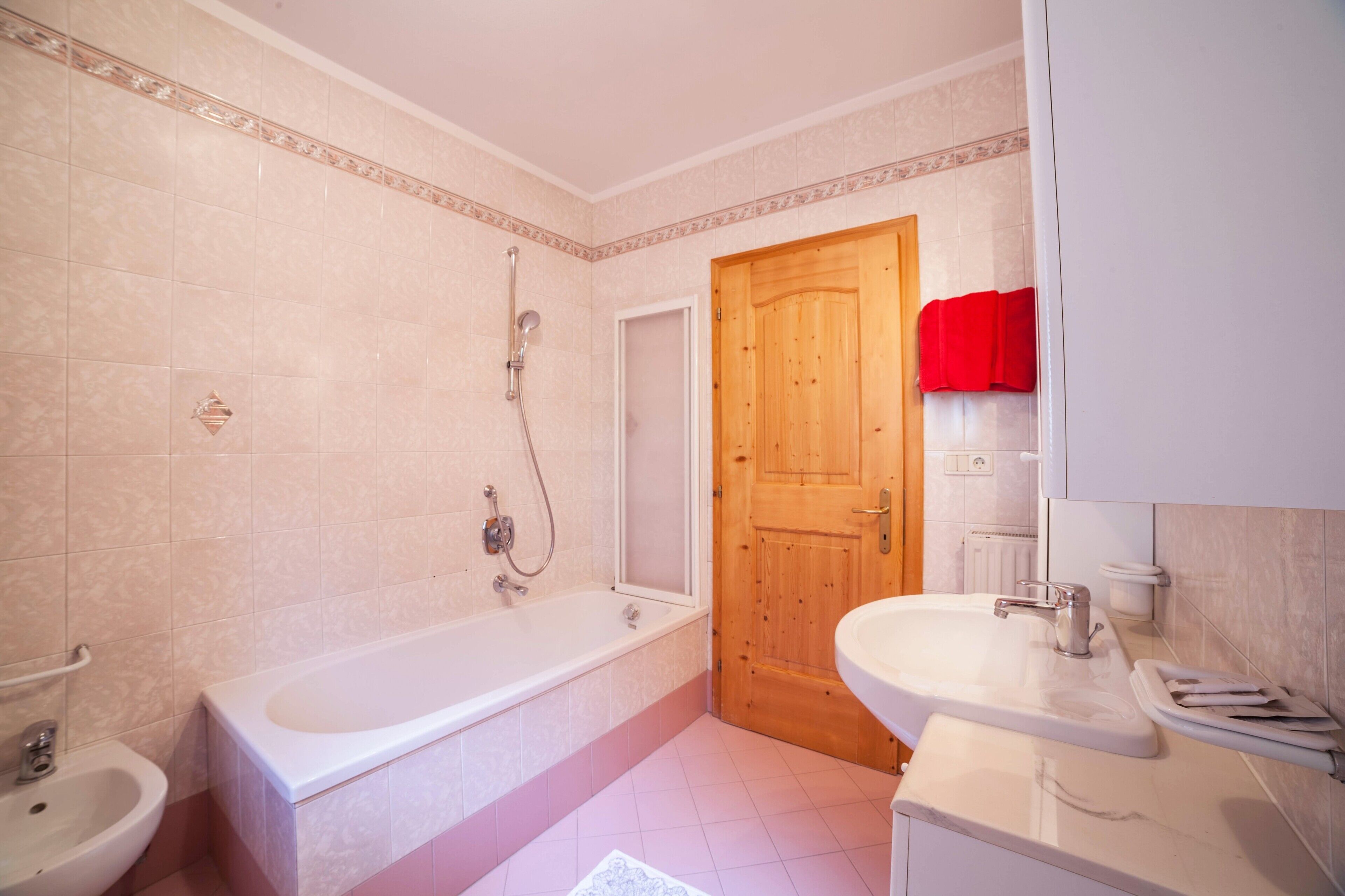 A bathroom with a bathtub, a sink, and a shower.