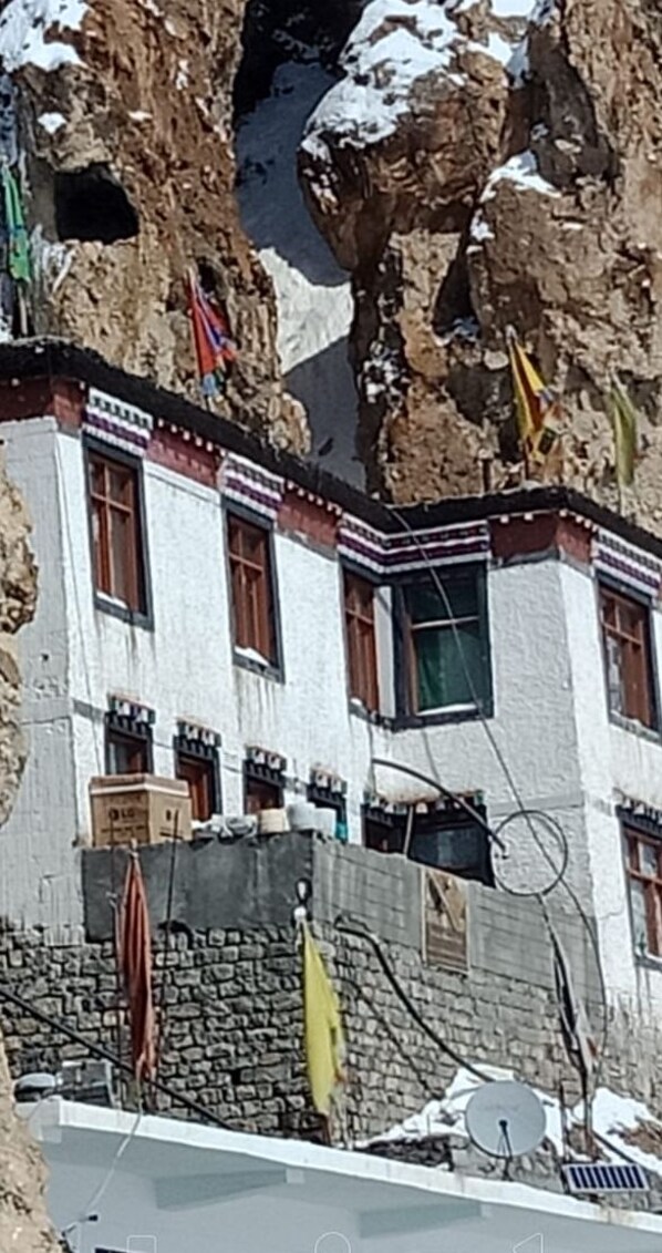 A building with a traditional architectural style, featuring a stone facade and multiple windows.
