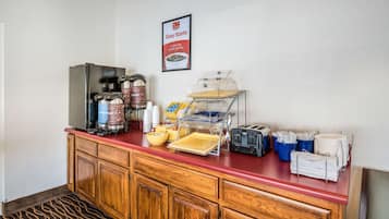 A hotel breakfast bar with a coffee maker, coffee urns, a toaster, and a sign advertising "Easy Starts".