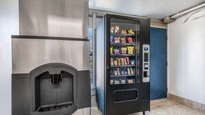 A vending machine with snacks and a water dispenser in a commercial setting. - Suburban Studios Middlesboro (Middlesboro)