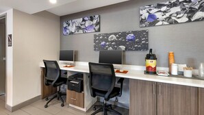 A modern office space with two desks, chairs, and a whiteboard. - MainStay Suites Oak Brook Terrace-Chicago (Villa Park)